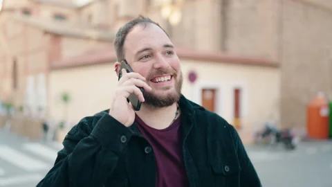 Young plus size man smiling confident talking on the smartphone at street Stock-Footage 172071826