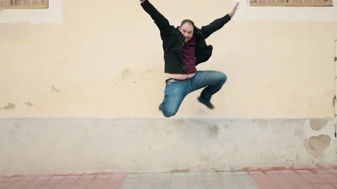 Young plus size man smiling confident jumping at street Video stock 172420256
