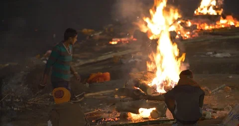 Young poor boy burning dead bodies in Manikarnika Ghat, Varanasi, India Stock Footage 113993743
