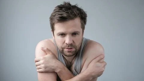 Young poor man shaking and freezing for winter Stock Photos