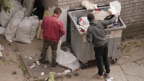 Young Poor Men Searches Something In Garbage Can Stock Footage 163637716