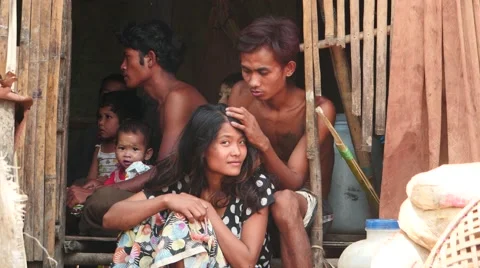 Young poor people in thatch house in Myanmar near Yangon Stock Footage 61131390