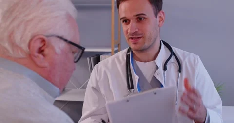 Young positive caring kind smiling male nurse, doctor, geriatric medicine Stock Footage 312898344
