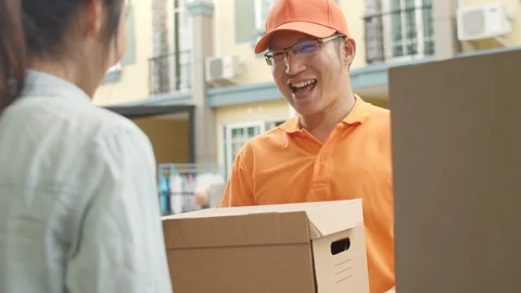 Young postal delivery courier man holding parcel boxes for sending to custome. Video stock 125955829