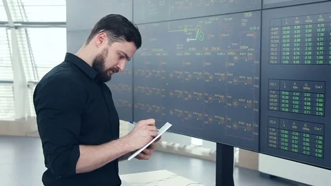 A young power engineer near the electronic data panel Video stock 73467819