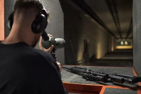 Young Practicing Target Shooting at Indoor Gun Club Stock Photos