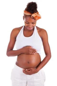 Young pregnant black woman touching her belly - african people Stock Photos