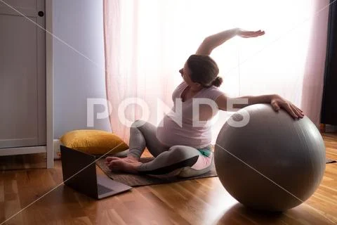 Concept Of Yoga And Fitness Pregnancy. Portrait Of A Young Model
