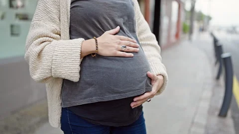 Young pregnant woman touching belly at s... | Stock Video | Pond5