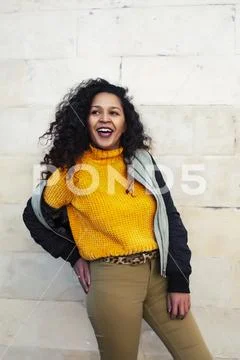 Young pretty afican american girl happy smiling on city background, lifestyle Stock Photos
