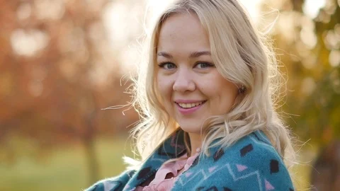 Young pretty blonde against the backdrop of an autumn park with evening light Stock-Footage 117925638