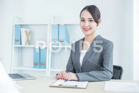 Young Pretty Business Woman With Notebook In The Office