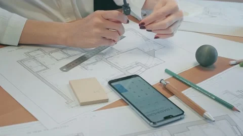 Young pretty engineer, architect or designer woman works with drawings in office Stock Footage 142727747