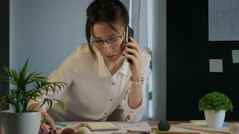 Young pretty engineer, architect or designer woman works with drawings in office Stock Footage 142727787