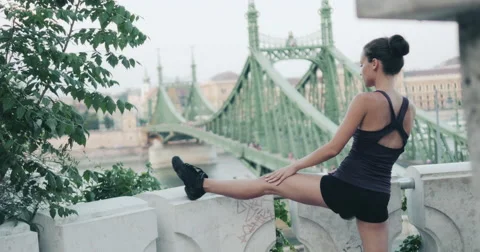 Young pretty female dancer warming up and stretching with panoramic view 4K Stock Footage 54805142