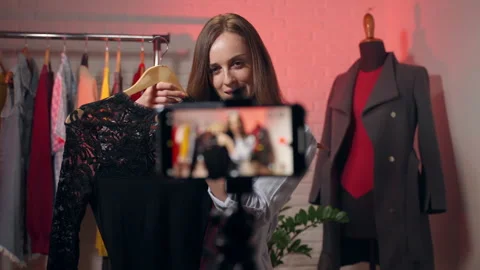 Young pretty female influencer live streaming in her local store using Stock Footage 301371353