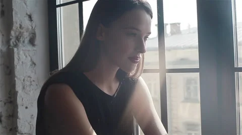 Young pretty female model posing expressively looking straight to the camera. Cl Video stock 54636748