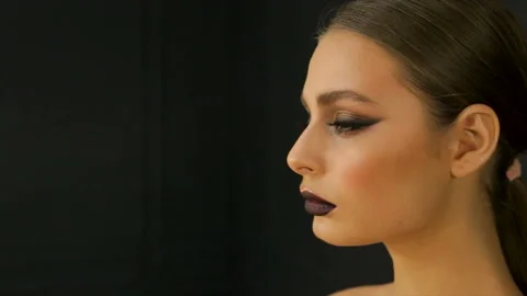 Young pretty female model posing expressively looking straight to the camera Stock Footage 86318696