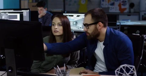 Young pretty female office worker discussing business project and having Stock Footage 82447772