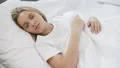 Young pretty female sleeping quietly in bad, comfortable orthopedic mattress 4k or 4k+ Resolution