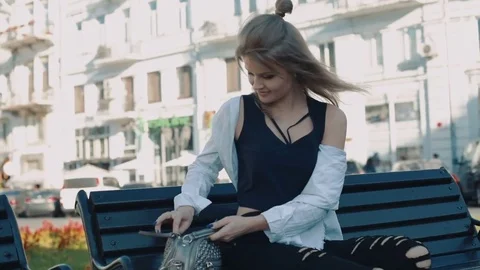 Young pretty female using her smartphone outdoors in city Stock-Footage 83148156