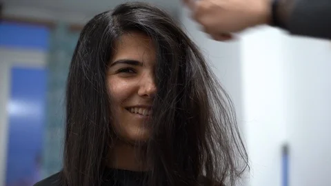 Young pretty girl with long black hair, closeup, hair straightening Stock-Footage 127445341