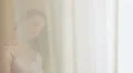 Young pretty girl looking into the window and feeling nostalgic HD Footage