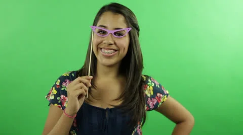 Young pretty girl makes comic actions with a funny spectacles Stock Footage 22844530