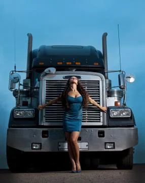 Young pretty girl posing before huge cargo truck Stock Photos