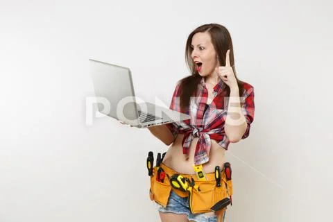 Young pretty handyman woman user in plaid shirt, denim shorts, kit tools belt Stock Photos