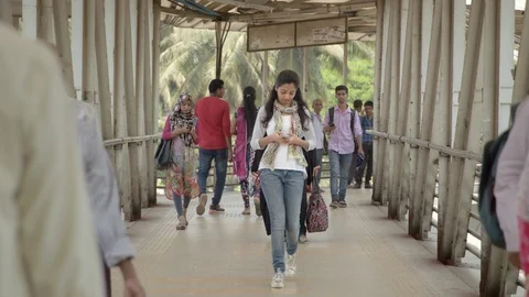 Young Pretty Indian Student Walking Towards The Camera, Holding A smartphone Stock Footage 90980932