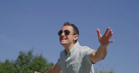 Young pretty man is singing and dancing in summer park 4k Video stock 138326543