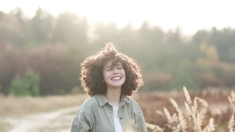 Young pretty mixed race teen girl outdoor in sunlight. Stock Footage