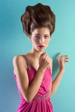 Young pretty model dressed in pink and with haute couture hair style Stock Photos