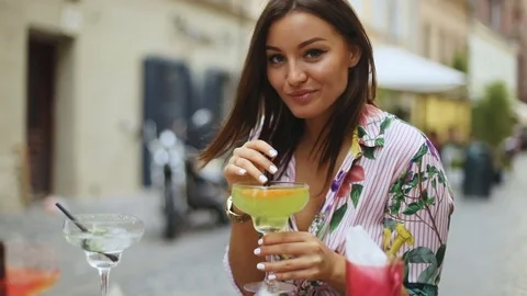 portrait of young sexy pretty woman drinking tasty cocktail