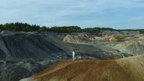 Young pretty slender red-haired woman with long hair in a white dress is playing Video stock 222532927