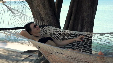 Summer relaxation. Full length top view of attractive young woman in  swimwear keeping hands behind head while lying down in hammock outdoors  13450494 Stock Photo at Vecteezy