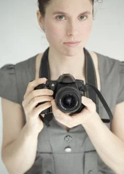 Young pretty woman with a DSLR camera Stock Photos