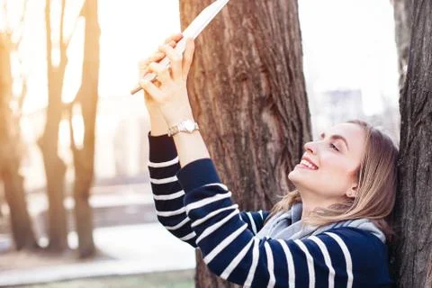 Young pretty woman is posing while photographing herself on tablet for soci.. Stock Photos