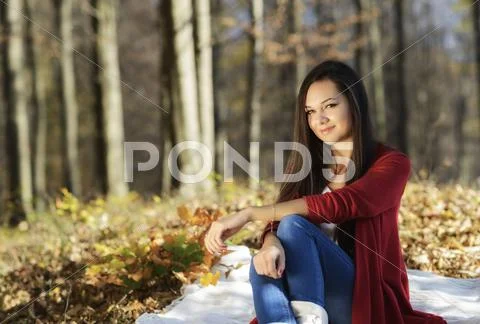 Young pretty woman relaxing in the autumn park Stock Photos