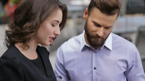 Young pretty woman talking to her colleague Stock Footage 64106970