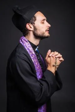 Young priest praying Stock Photos