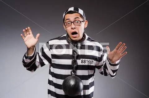 Young prisoner in chains against gray Stock Photos