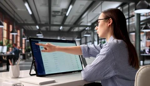 Young Procurement Manager Uses Touchscreen To Analyze Supplier Data Efficient Stock Photos