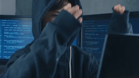 Young prodigy boy hacker programmer in hood working at the computer in the data Stock Footage 101711595
