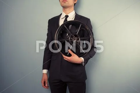 Young producer with film reel Stock Photos