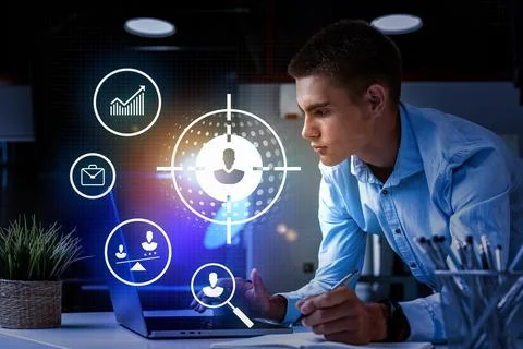 Young professional analyzing data on laptop with digital icons in modern office Stock Photos