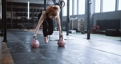 Young professional athletic red haired coach woman doing split stretch exercise Stock Footage 116881307