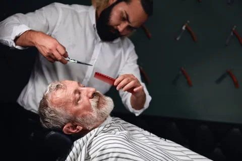 Young professional barber working with tools Stock Photos