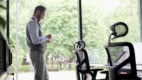 Young professional businessman worker using digital tablet standing in office Video stock 218312823
